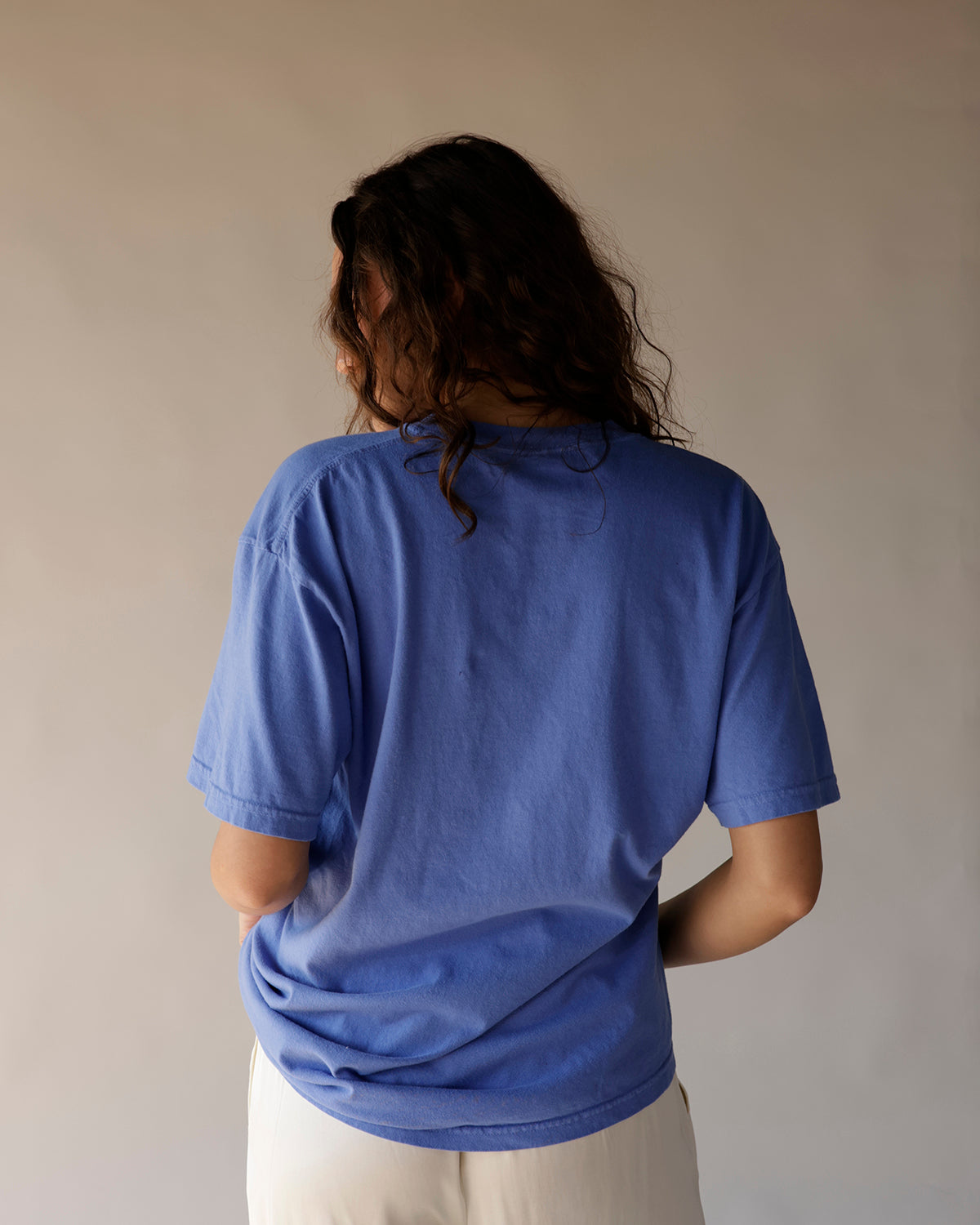 Blue oversized graphic tee shown from the back, relaxed fit, short sleeves