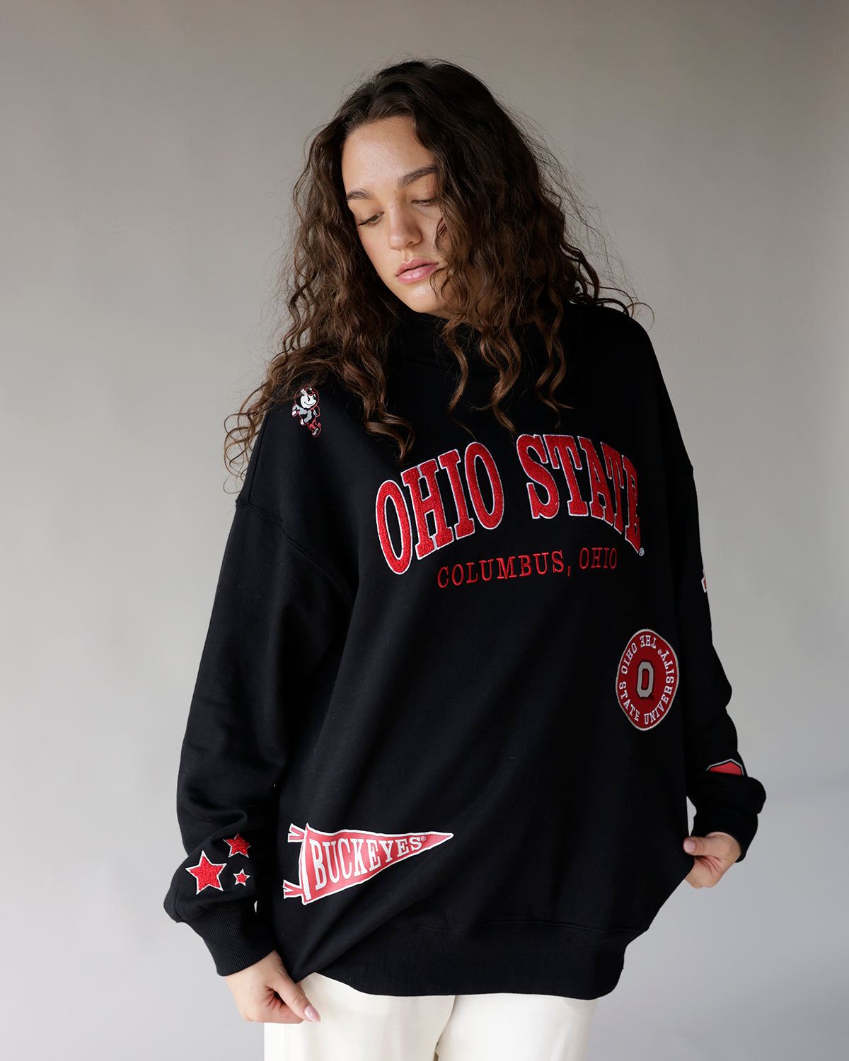 Oversized black crewneck sweatshirt with red Ohio State patches and graphics