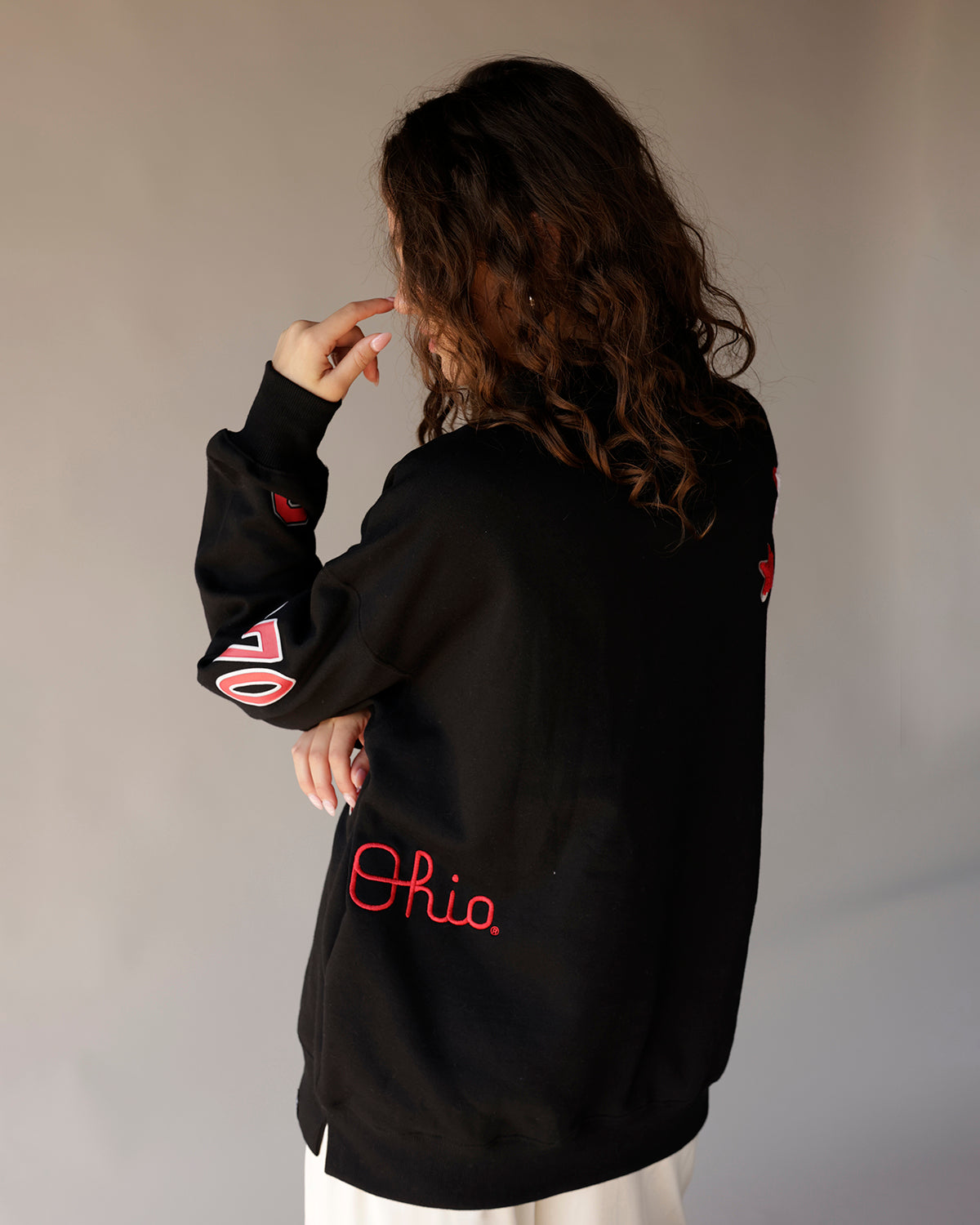 Black oversized sweatshirt with red Ohio script and sticker graphics on sleeves