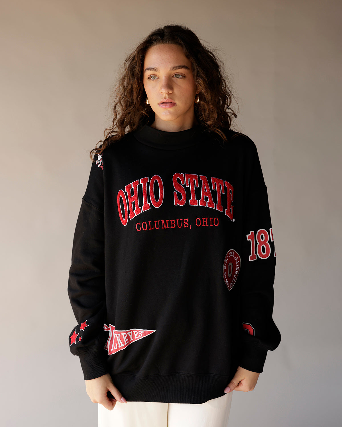Black oversized crewneck sweatshirt with red Ohio State graphics and patches