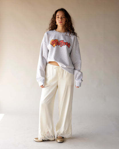 Heather gray crewneck sweatshirt with retro heart and script graphic in orange and red