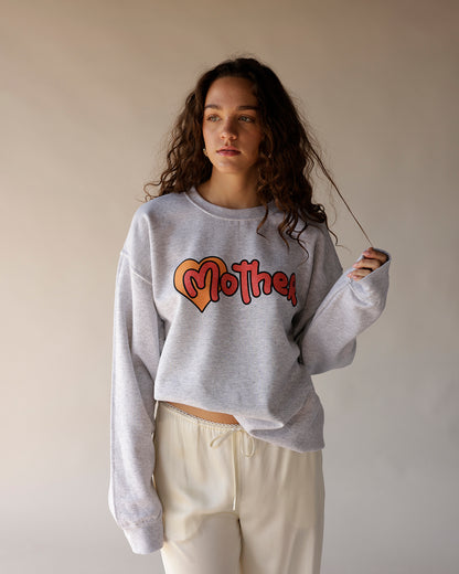 Heather gray oversized crewneck sweatshirt with retro heart graphic and script lettering
