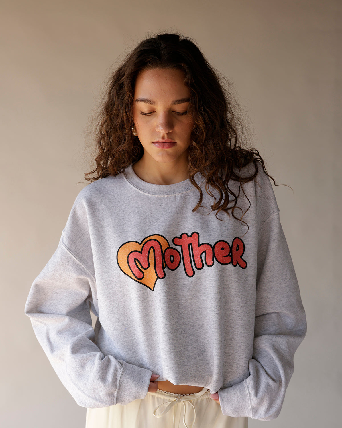 Gray heather crewneck sweatshirt with heart and retro bubble letter graphic