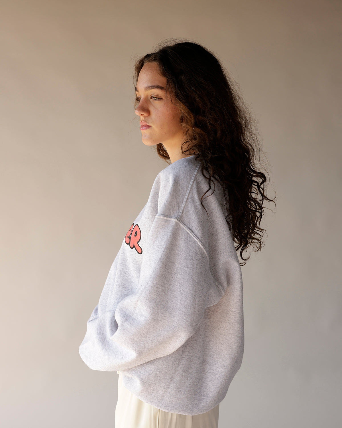 Oversized heather grey graphic crewneck sweatshirt with pink bubble letter print