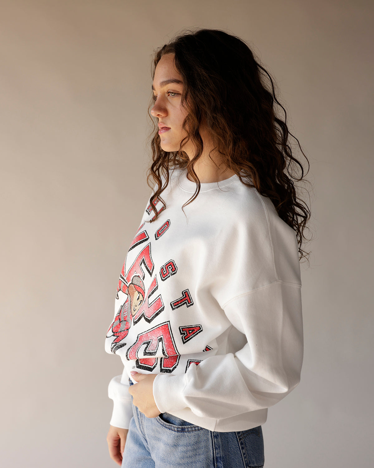 White Ohio State Brutus crewneck sweatshirt with red collegiate graphic print