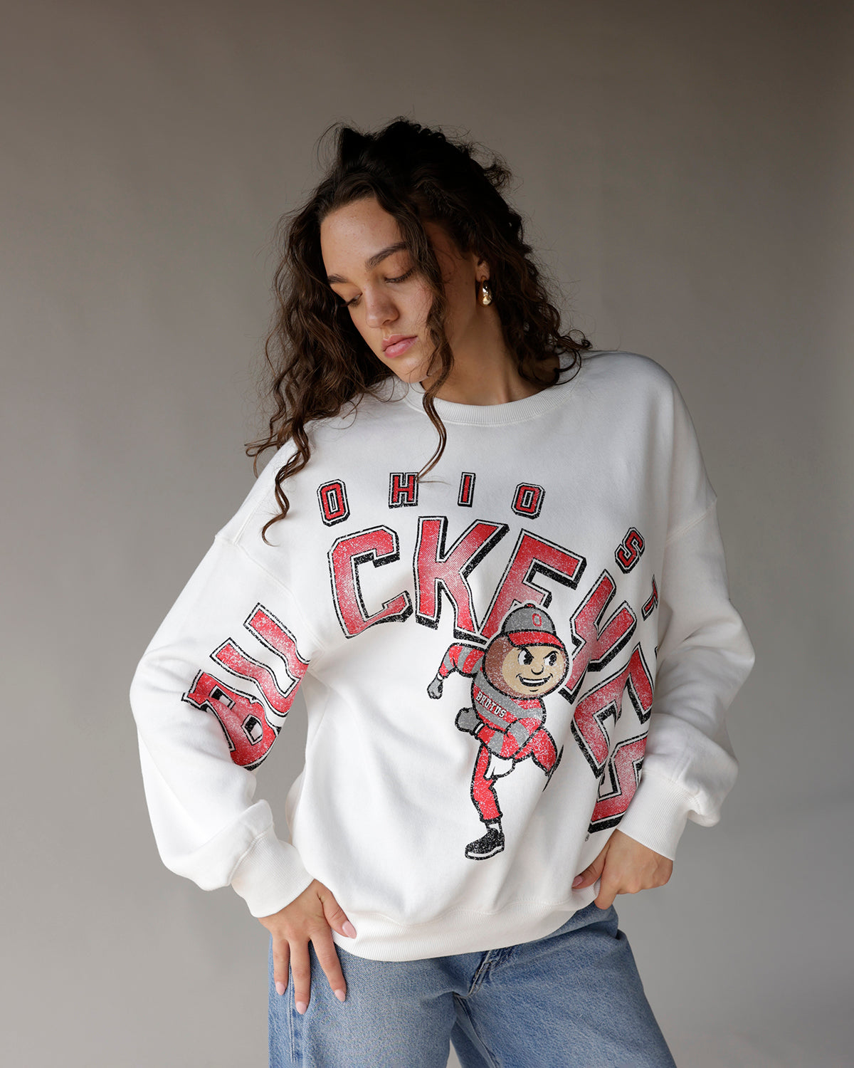 White Ohio State Buckeyes crewneck sweatshirt with Brutus mascot graphic in red and black