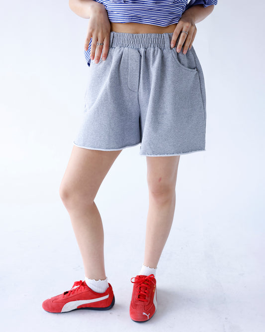grey sweat shorts with frayed hems and elastic waistband