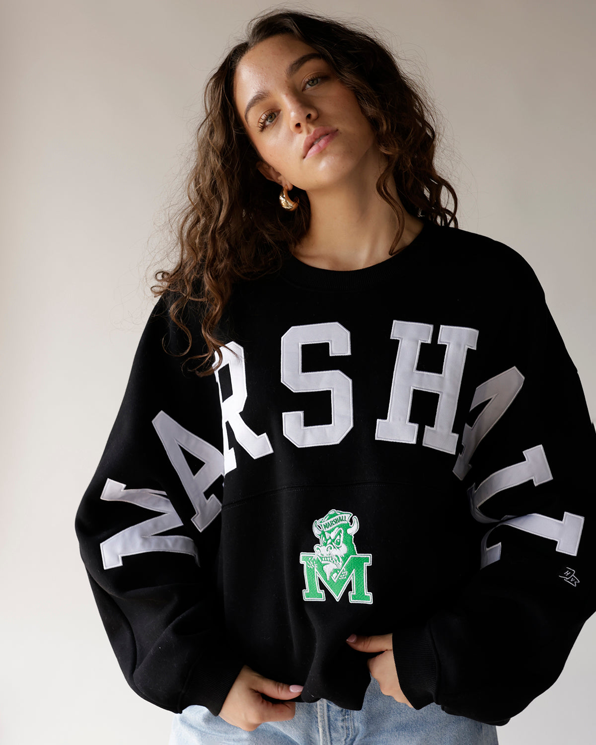 Black Marshall varsity crewneck sweatshirt with white lettering and green mascot logo