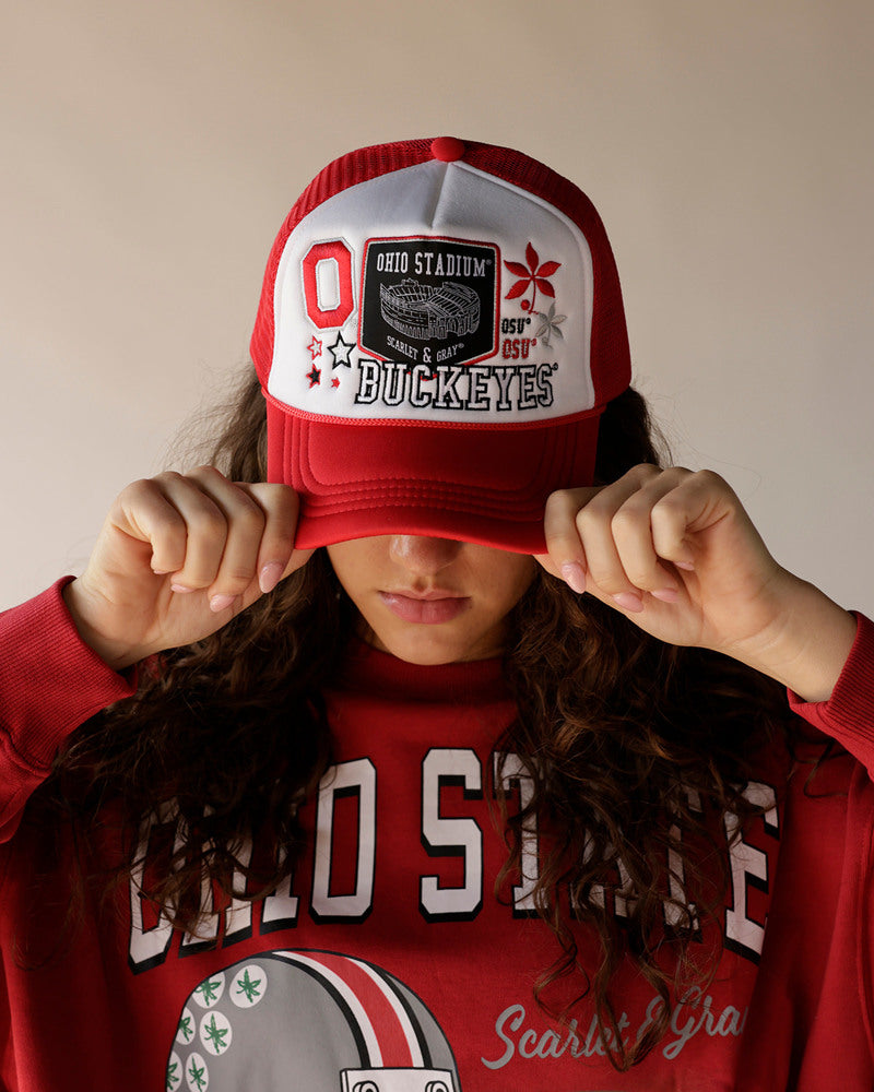 Woman wearing red Ohio State Buckeyes trucker hat and matching red sweatshirt