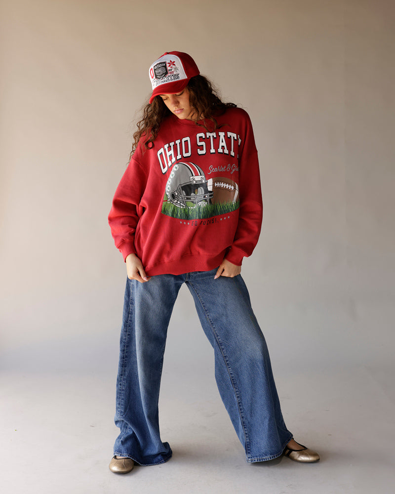 Red Ohio State football graphic sweatshirt styled with wide-leg jeans and trucker hat