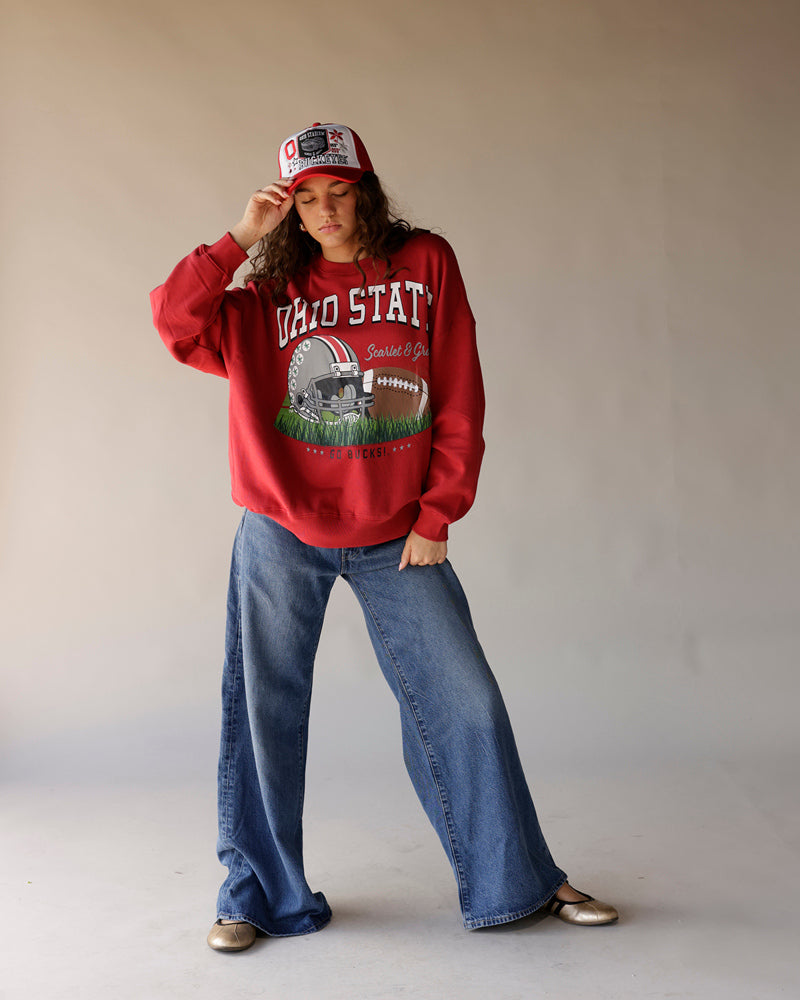 Women's red Ohio State Buckeyes crewneck sweatshirt with wide-leg jeans and matching cap