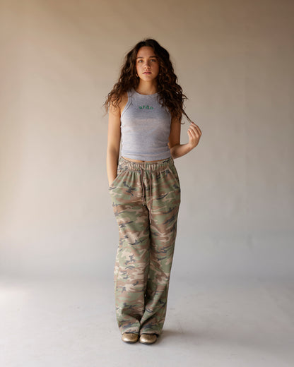 Gray sleeveless racerback crop tank top with green arched text graphic