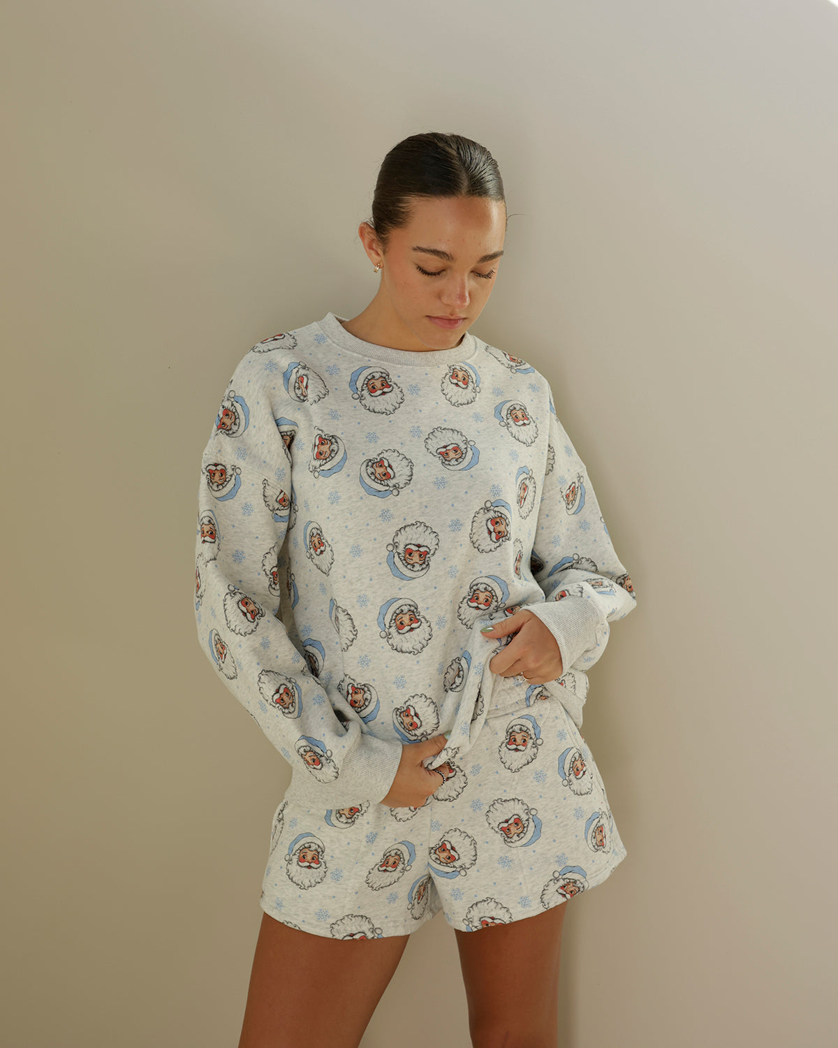 women's heather gray christmas sweatshirt and shorts set featuring an allover vintage santa face print with baby blue santa hats and snowflake details