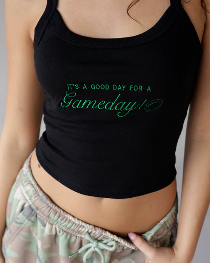 Black crop tank top with green embroidered gameday football slogan graphic
