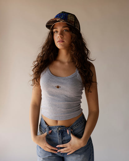 Kentucky Wildcats camo trucker hat with blue embroidered logo, worn by model