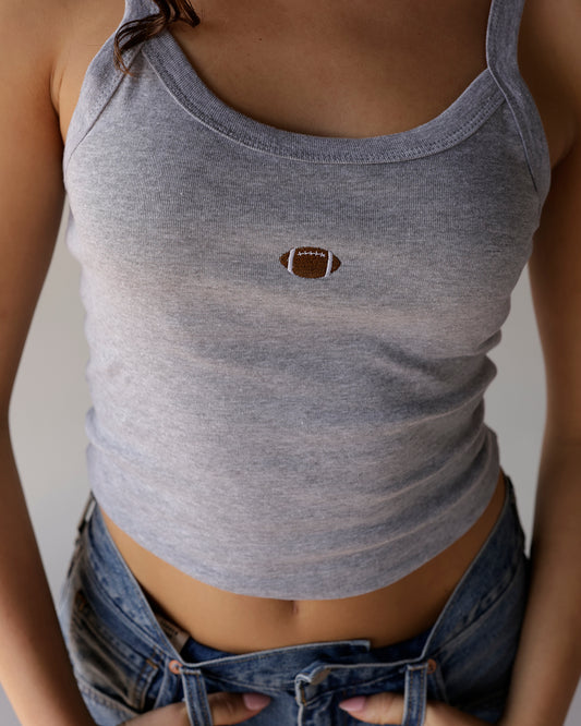 Gray cropped tank top with small embroidered football graphic on chest