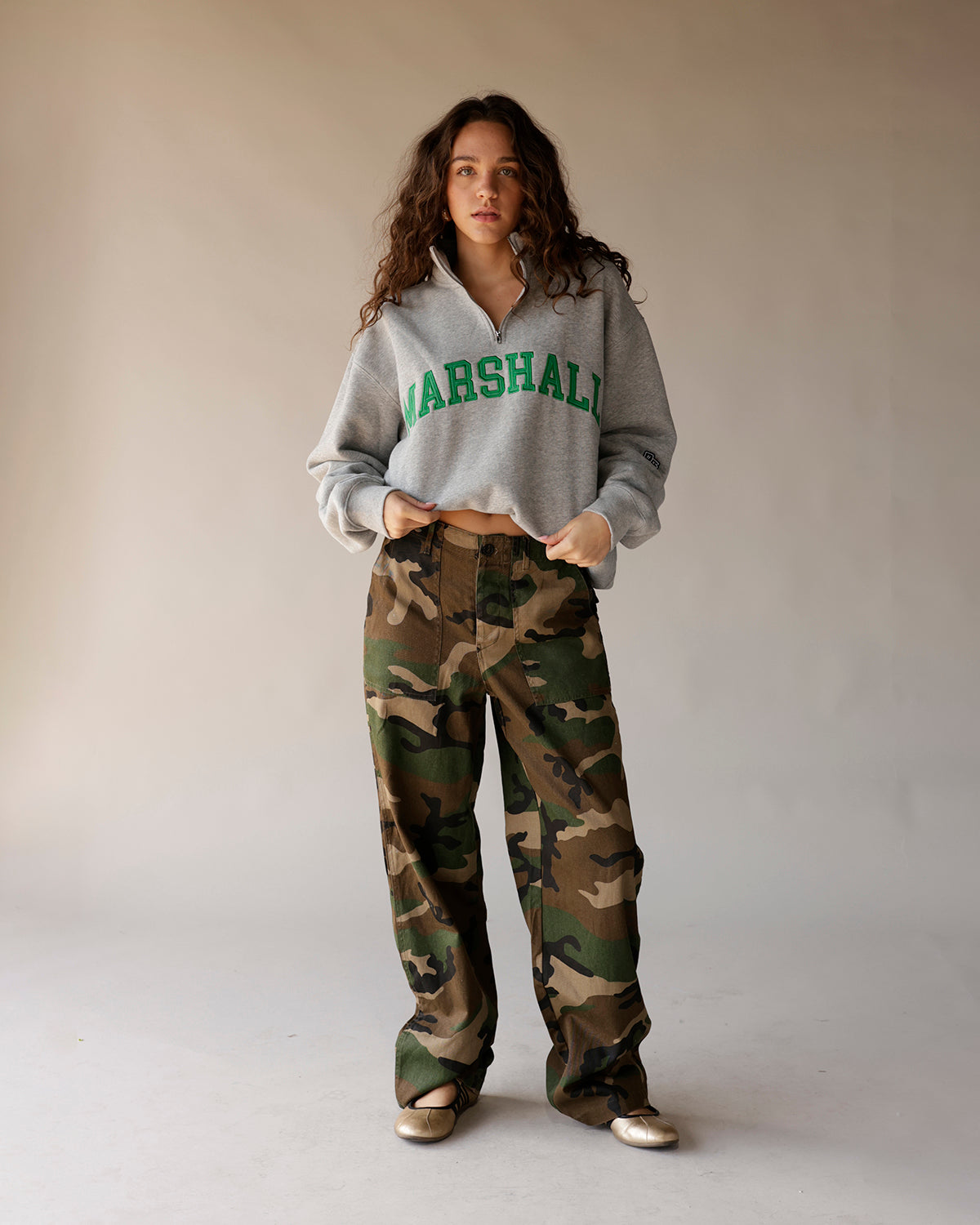 Gray Marshall quarter-zip cropped sweatshirt with green collegiate lettering on model