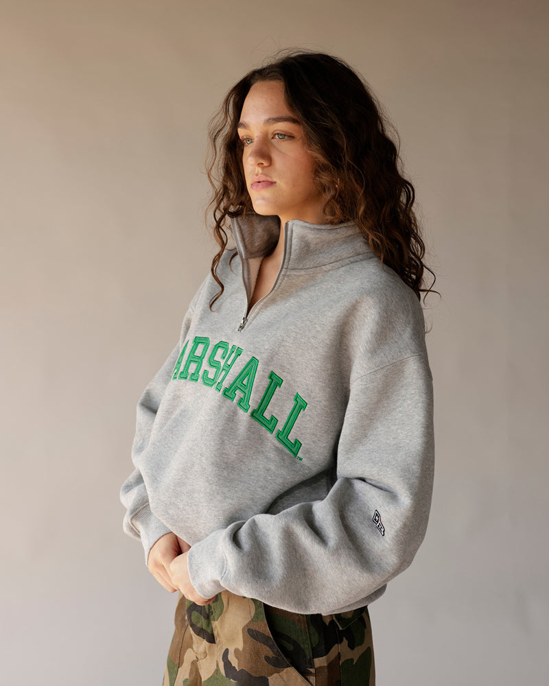 Gray Marshall quarter-zip sweatshirt with green lettering, worn with camo pants