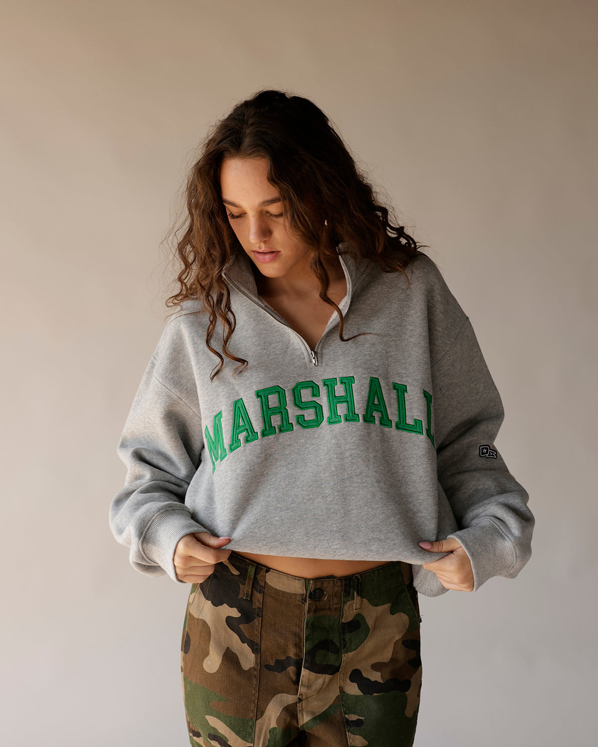 Gray cropped quarter-zip Marshall sweatshirt with green varsity lettering