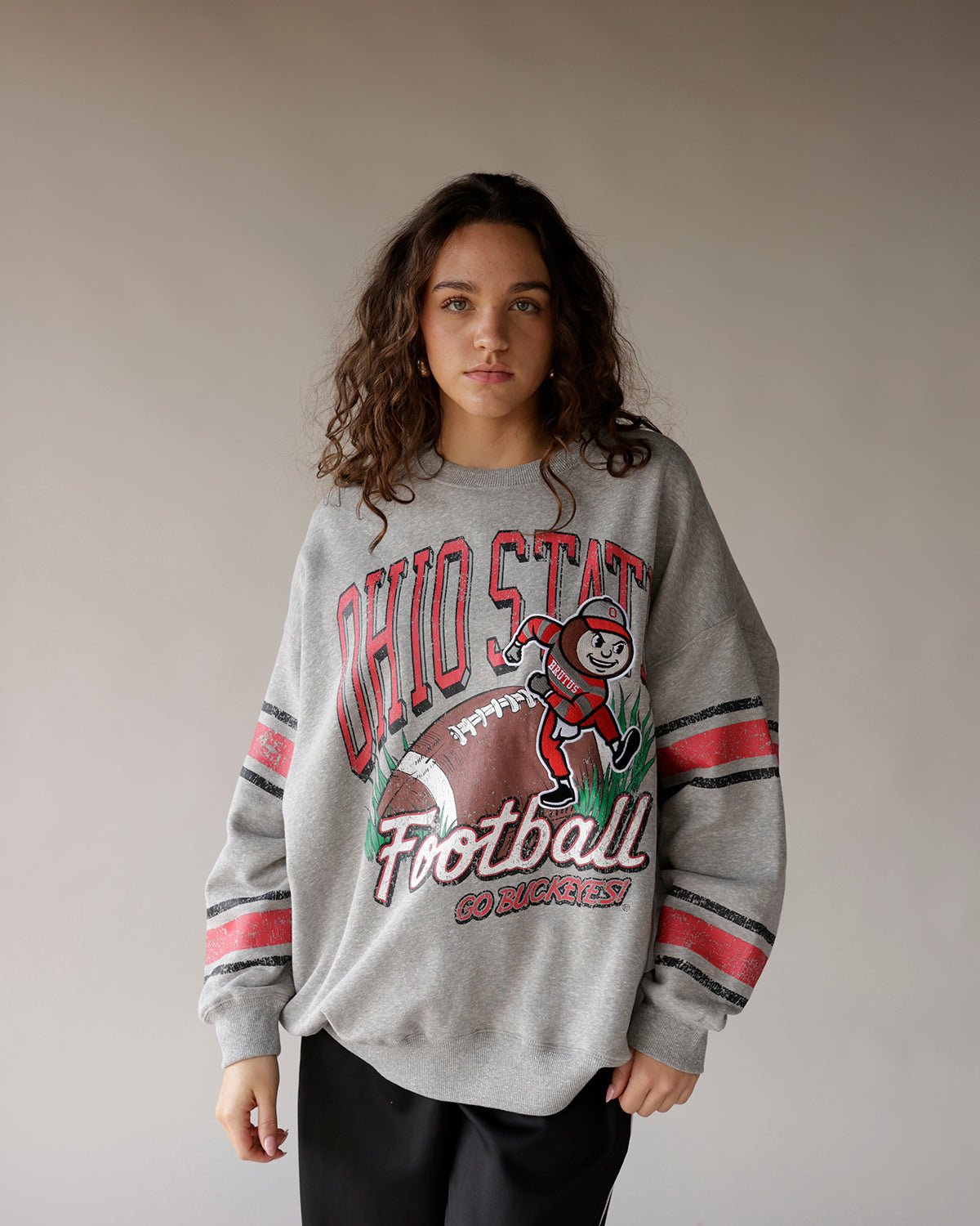 Gray Ohio State Football oversized crewneck sweatshirt with Brutus Buckeye graphic and striped sleeves