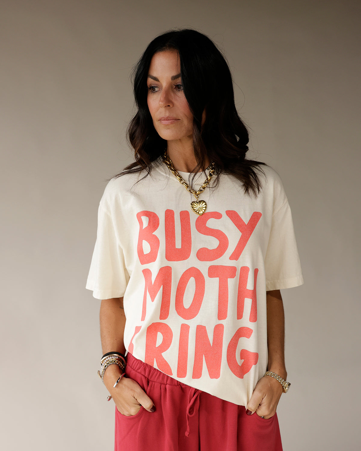 Cream oversized graphic tee with bold coral Busy Mothering print by Salty Babe Threads