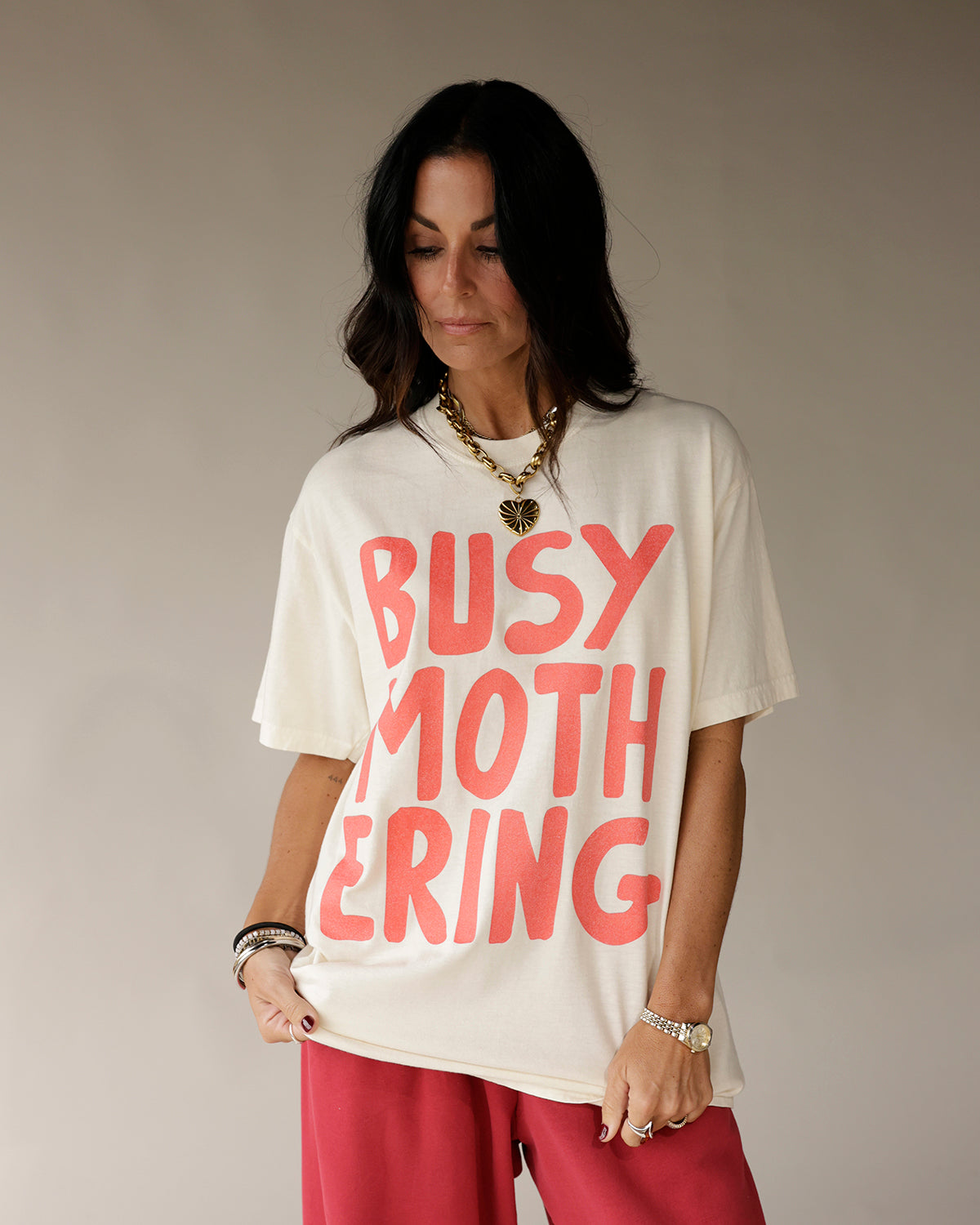 Oversized cream graphic tee with bold coral BUSY MOTHERING text print