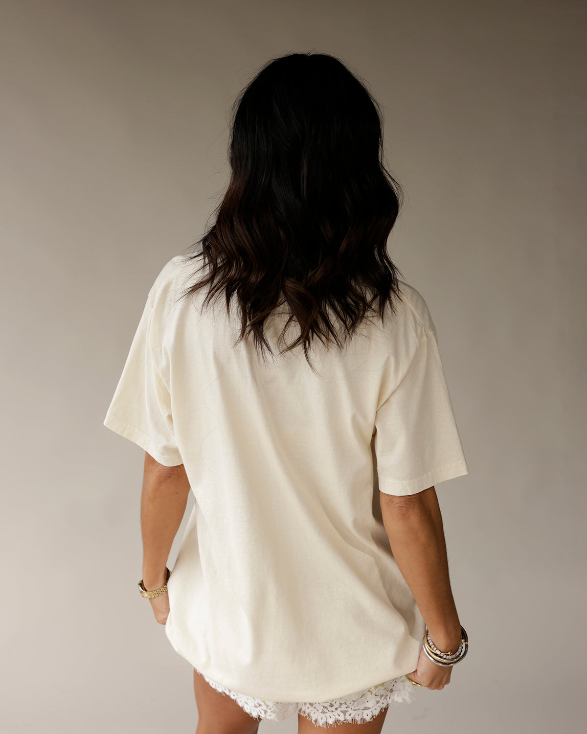 Cream oversized graphic tee back view, drop shoulders, short sleeves