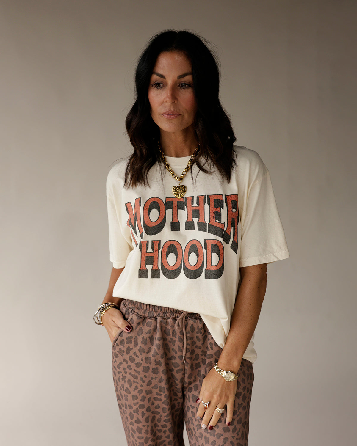 Cream oversized graphic tee with bold MOTHERHOOD retro print in rust and black