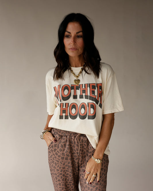 Cream oversized graphic tee with bold MOTHERHOOD retro print in rust and black