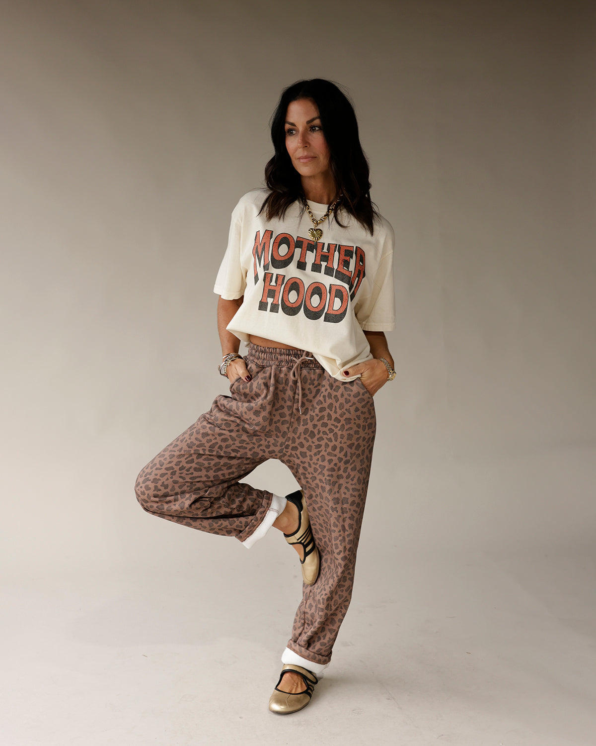 Cream vintage graphic tee with bold red and black MOTHERHOOD text print