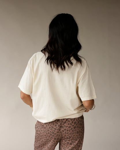 Oversized cream vintage graphic tee, back view, paired with leopard print pants.