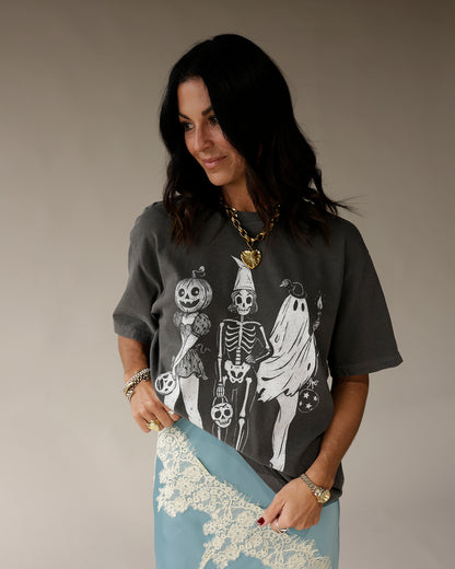 Dark gray oversized graphic tee with Halloween skeleton, ghost, and pumpkin print