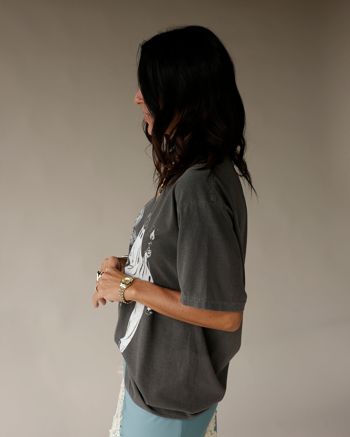 Oversized charcoal gray Halloween graphic tee with white figure print, side view