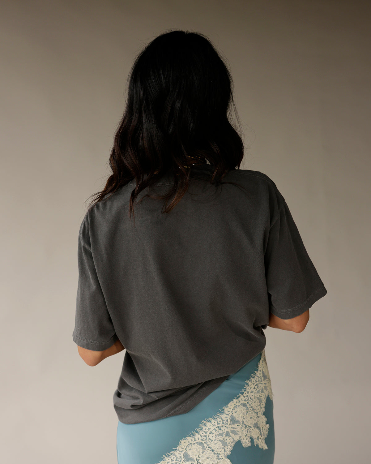 Oversized charcoal gray graphic tee, back view, relaxed fit short sleeves