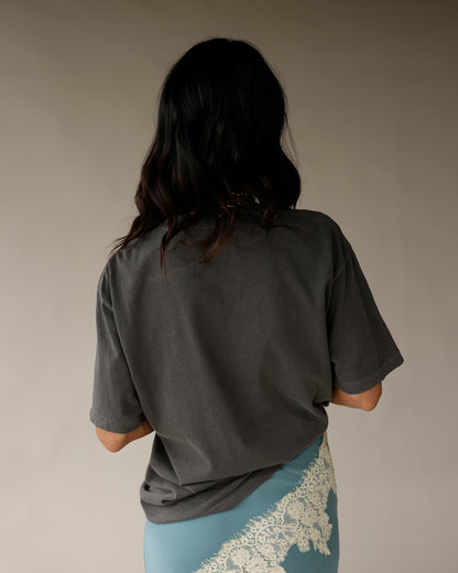 Oversized charcoal gray graphic tee, back view, relaxed fit short sleeves