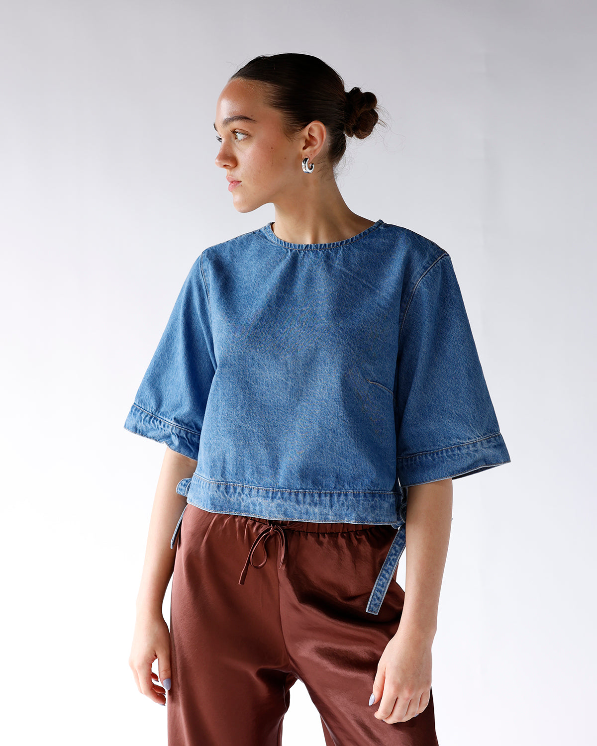 blue denim top with wide short sleeves and side tie details