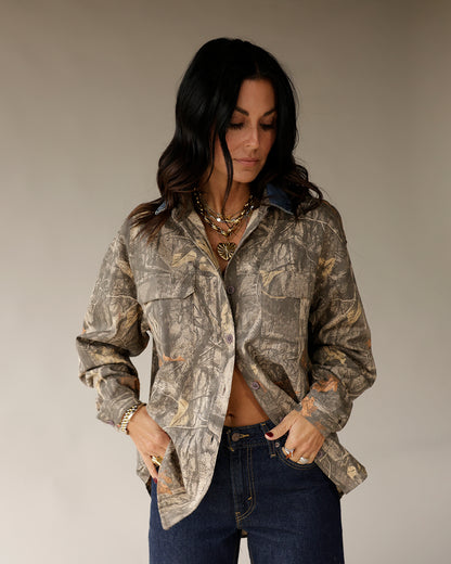 Women's oversized camo print button-up shacket with chest pockets and long sleeves