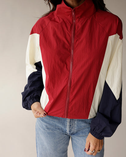 Red, white, and navy colorblock zip-up windbreaker jacket with mock neck