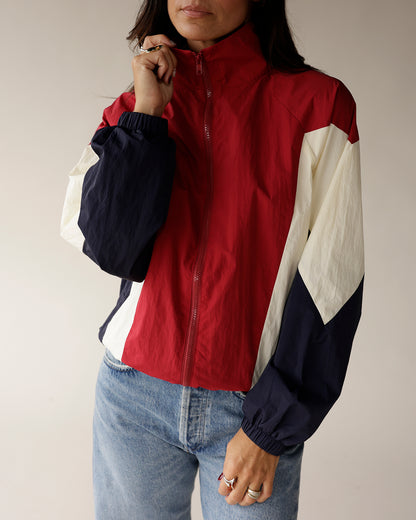 Red, white, and navy colorblock zip-up windbreaker jacket with elastic cuffs