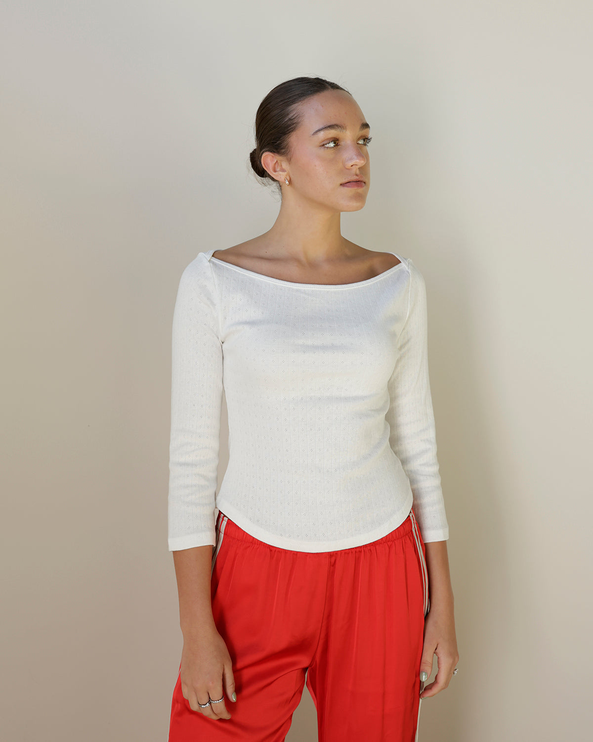 loucia ivory fitted short sleeve top featuring delicate pointelle eyelet knit detailing, vertical ribbing and a wide open neckline.