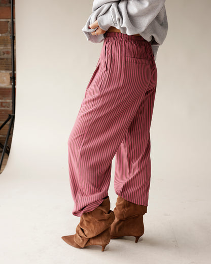 Pink and dark stripe wide-leg dressy pants with elastic waist, worn with brown suede boots.