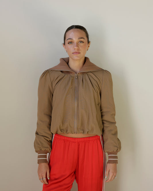 camel brown cropped zip-up jacket with oversized ribbed knit collar, gathered shoulders, striped knit cuffs and front pockets.