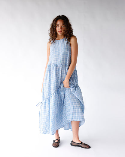 Blue and white gingham sleeveless maxi dress with tiered ruffle skirt and drawstring detail