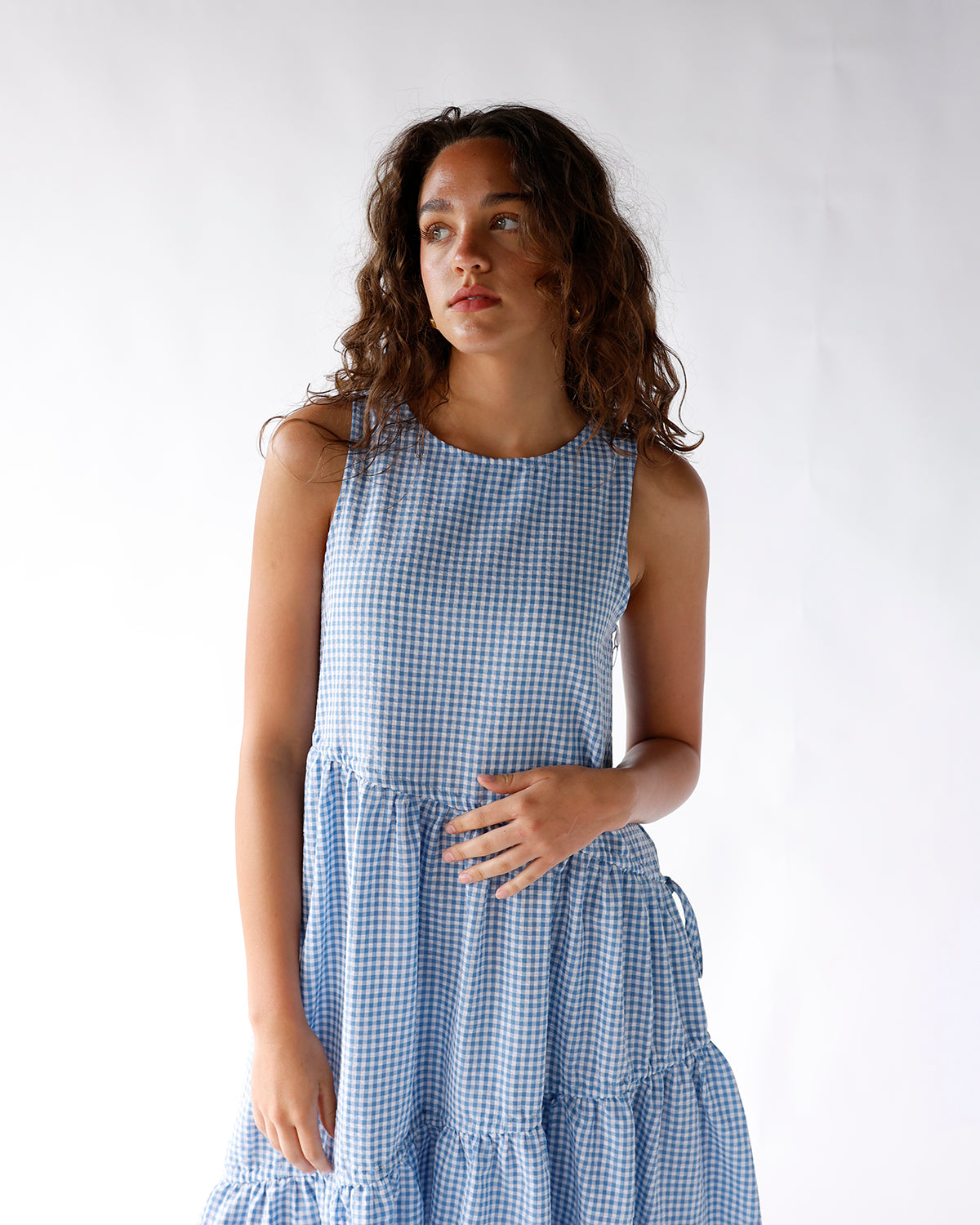 Sleeveless blue gingham maxi dress with tiered ruffle skirt and round neckline