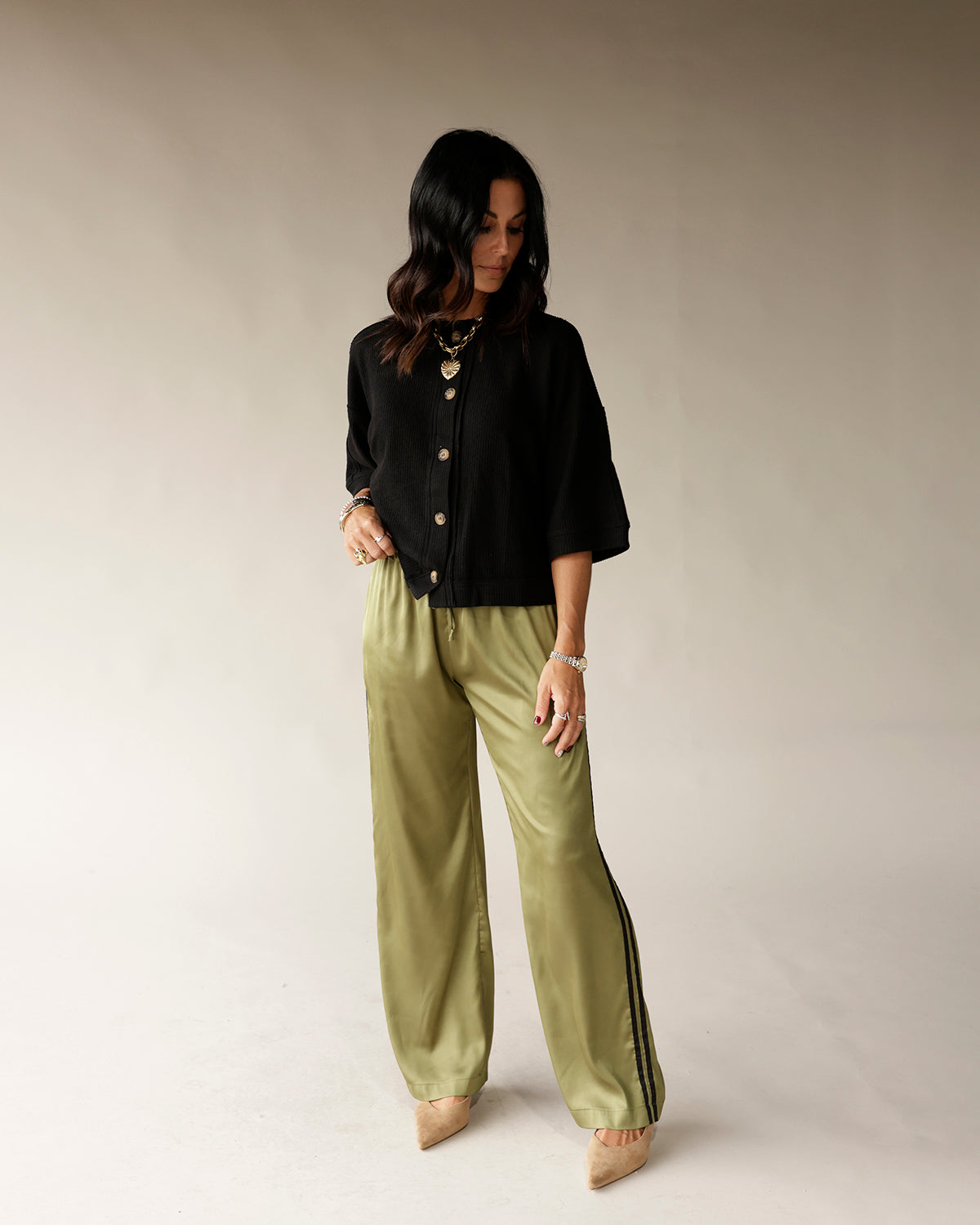 Black button-front cropped cardigan top with three-quarter sleeves on model