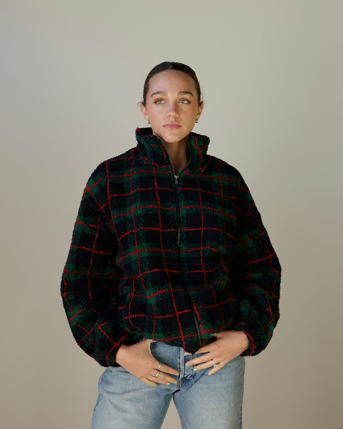 women's oversized plaid sherpa jacket featuring forest green, navy and red tartan print, plush fleece texture, high stand collar, zip front and pockets.