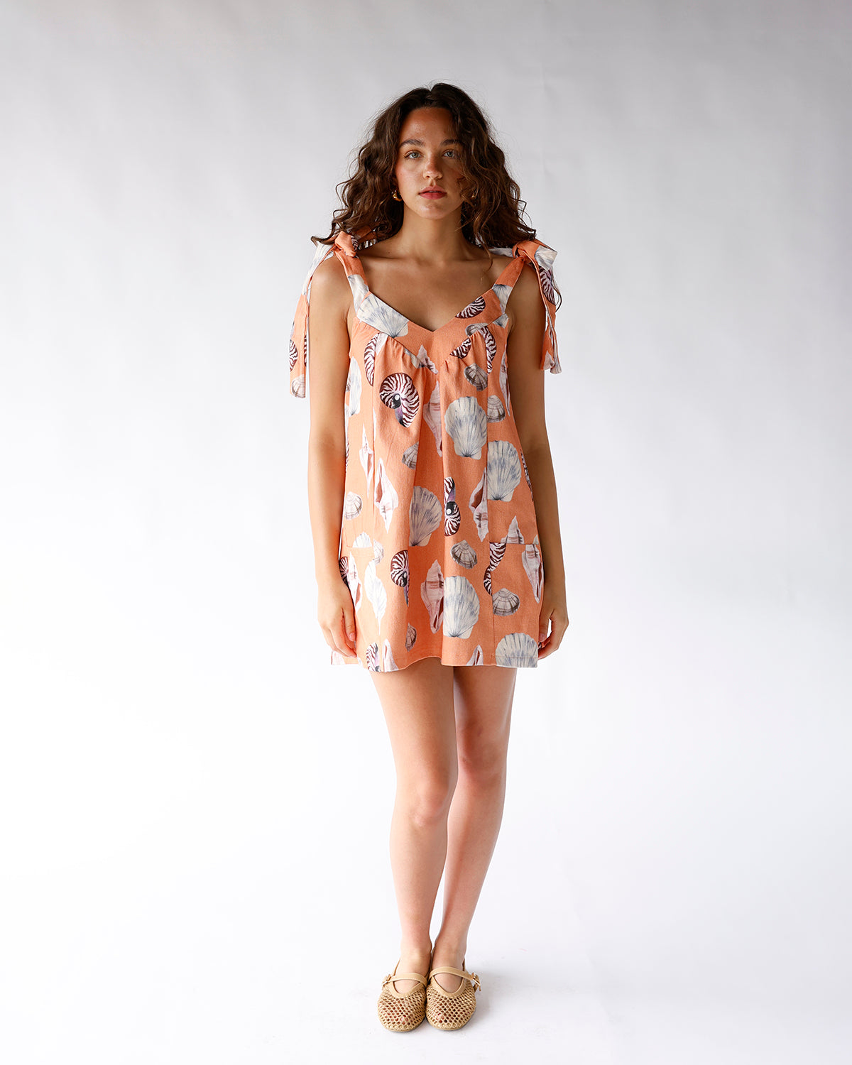orange seashell print mini dress with adjustable tie shoulder straps and side pockets orange seashell print mini dress