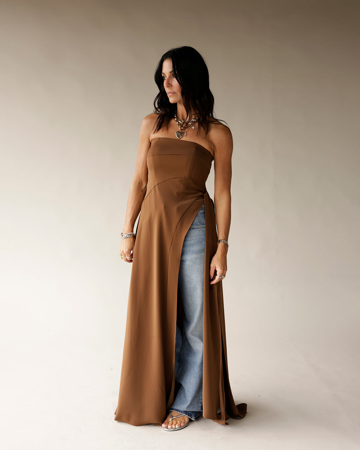 Camel strapless maxi tunic with front slit, worn over wide-leg jeans