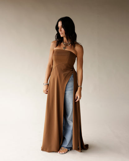 Camel strapless maxi tunic with front slit, worn over wide-leg jeans