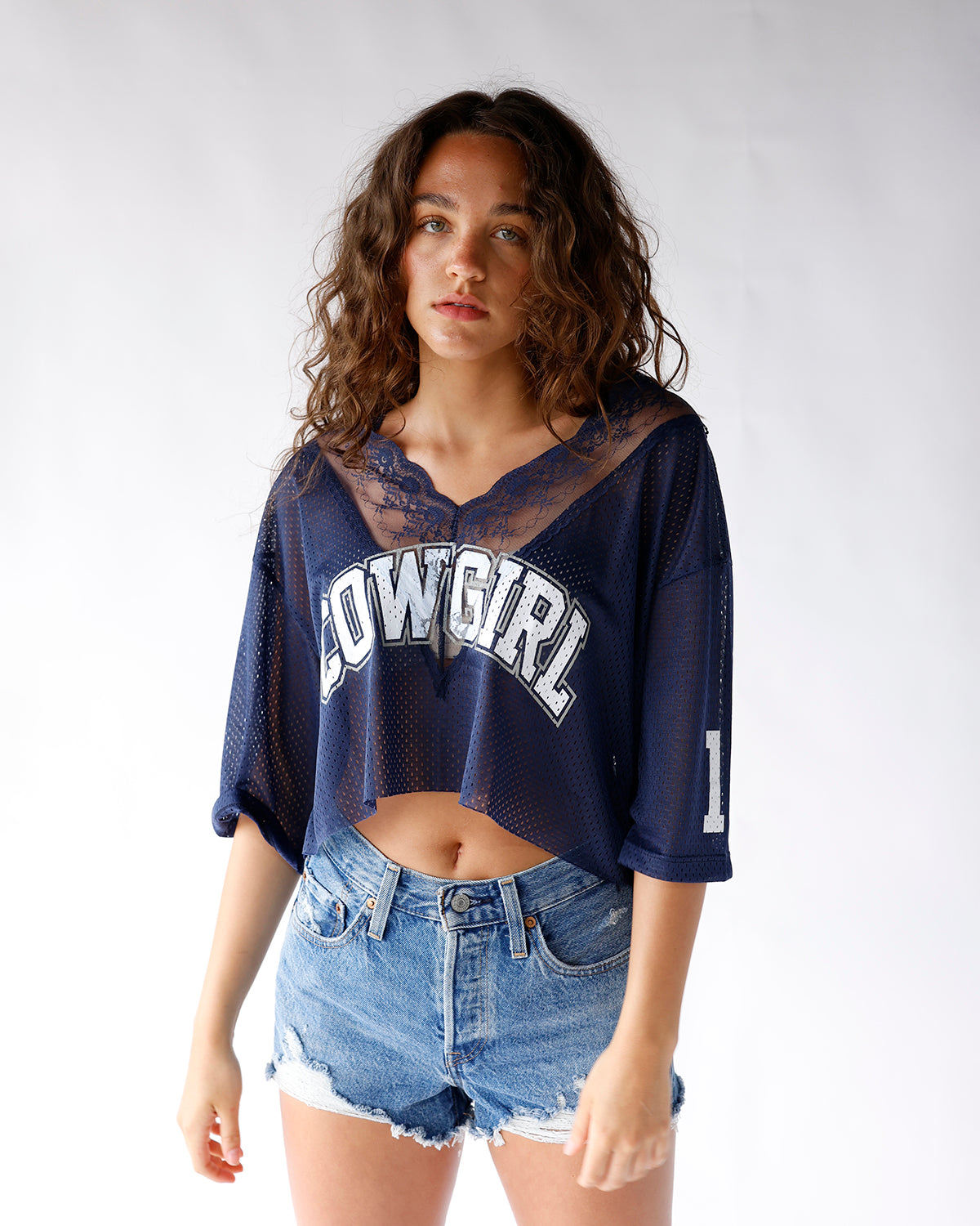navy short sleeve cowgirl sheer jersey with lace detailing around the v-neckline